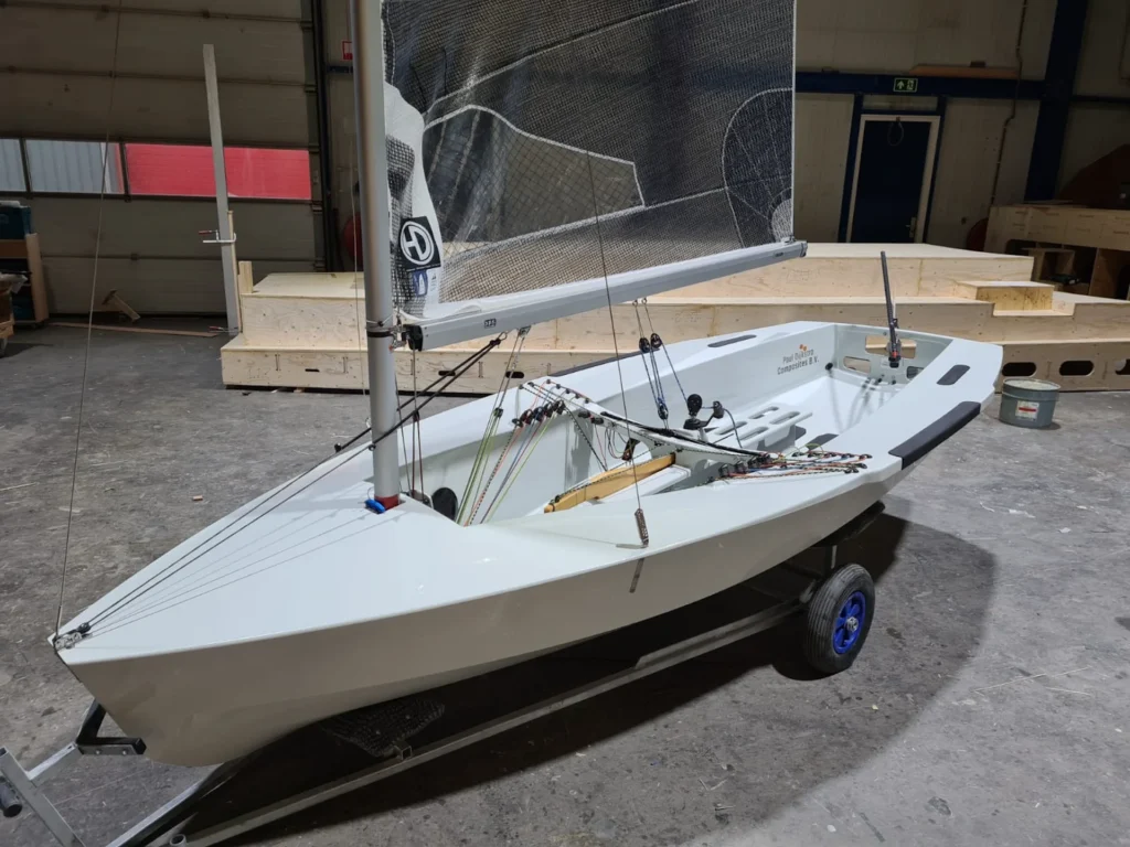 Kleine witte zeilboot op een boottrailer